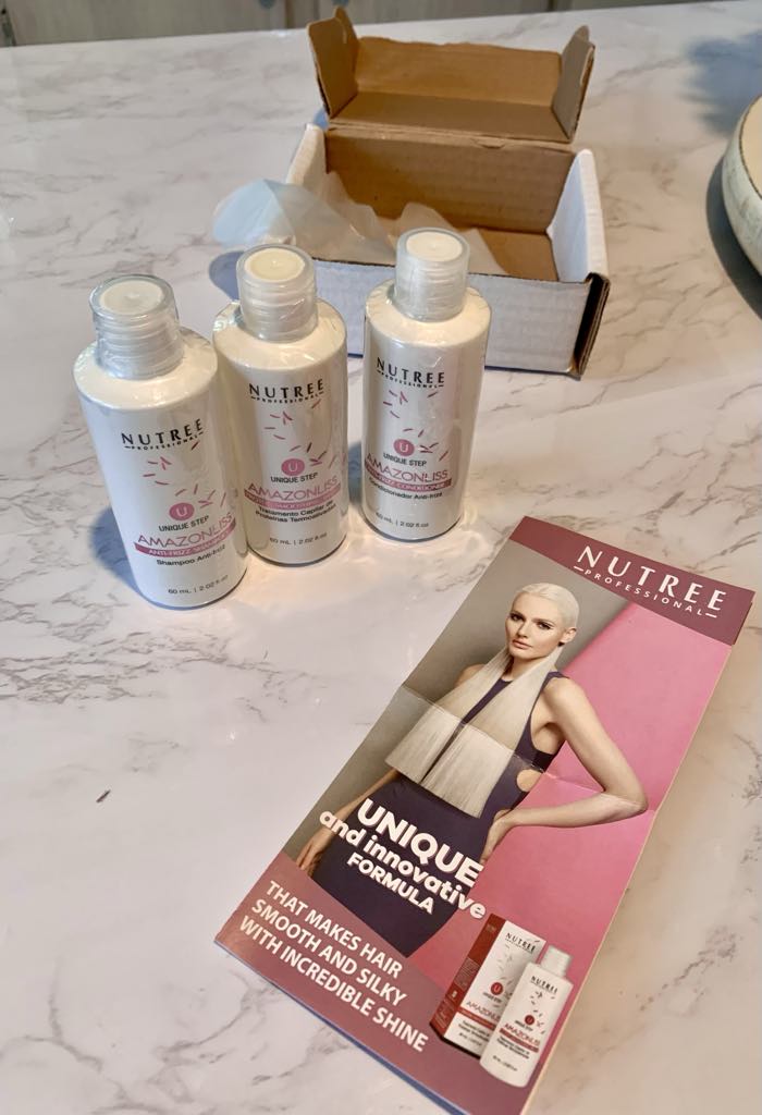 Nutree Amazonliss keratin treatment kit (product photo) - 757 Biz Click Nutree Amazonliss hair treatment kit bottles and brochure on a countertop used for frizzy hair control.